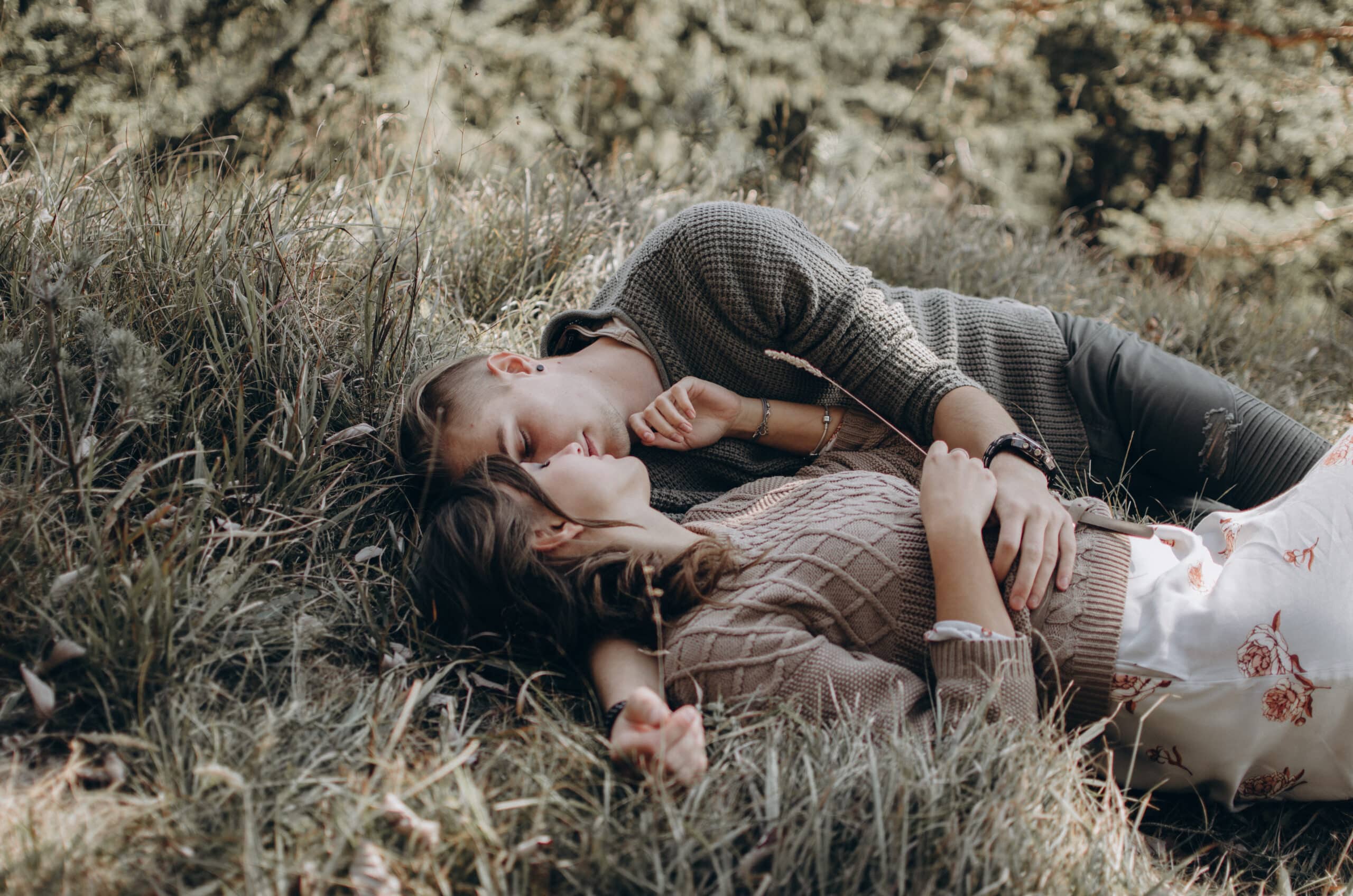young couple lying on the grass
