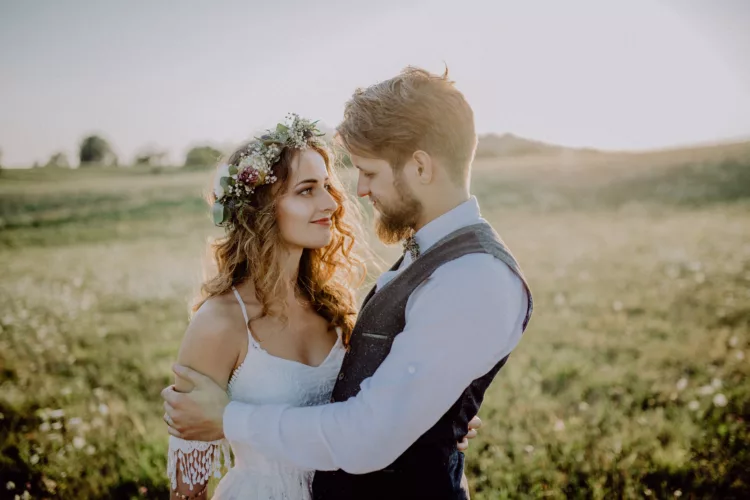 Beautiful bride and groom at sunset in green nature