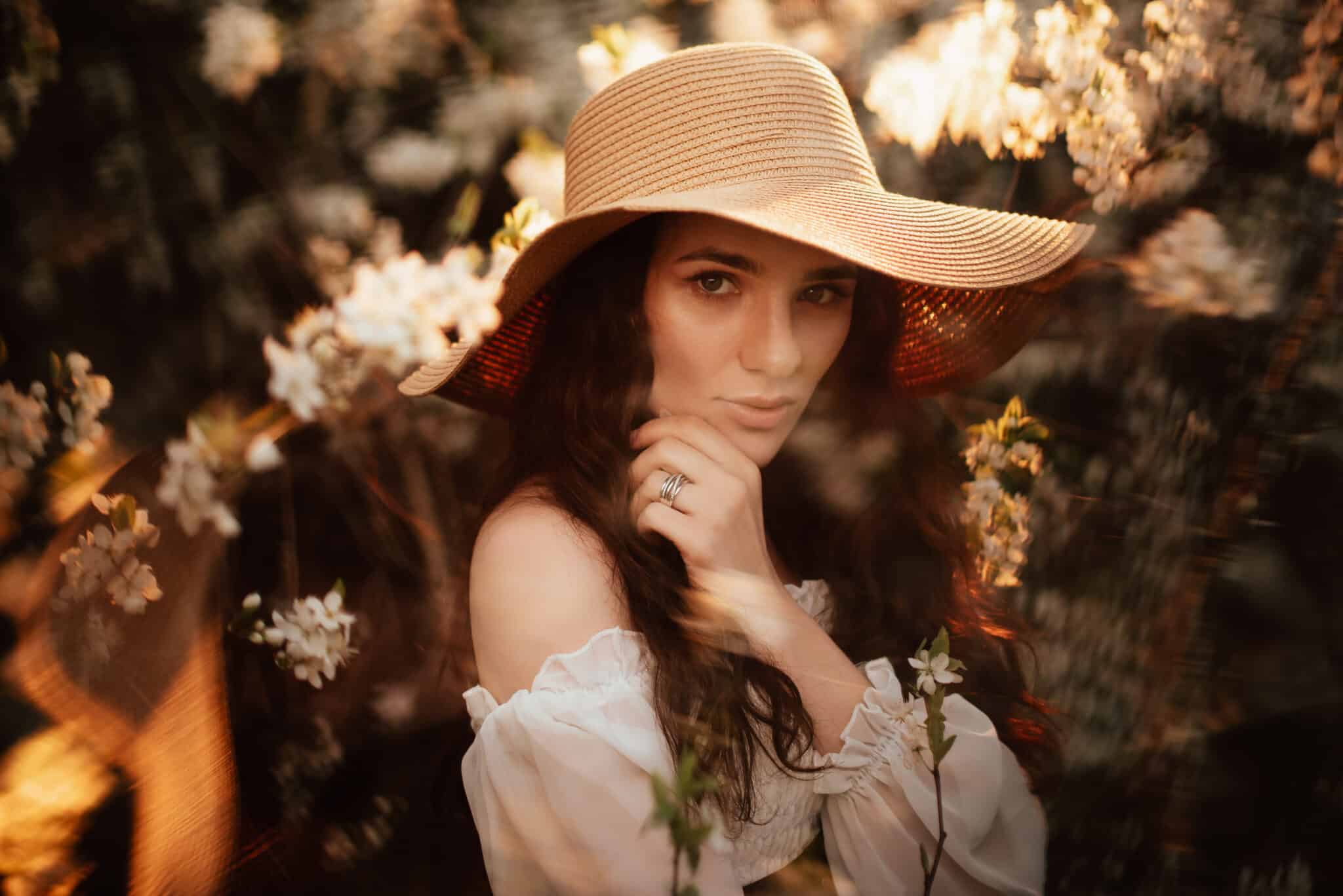Portrait of a romantic girl in a blooming garden with elements of phantasmagoria.