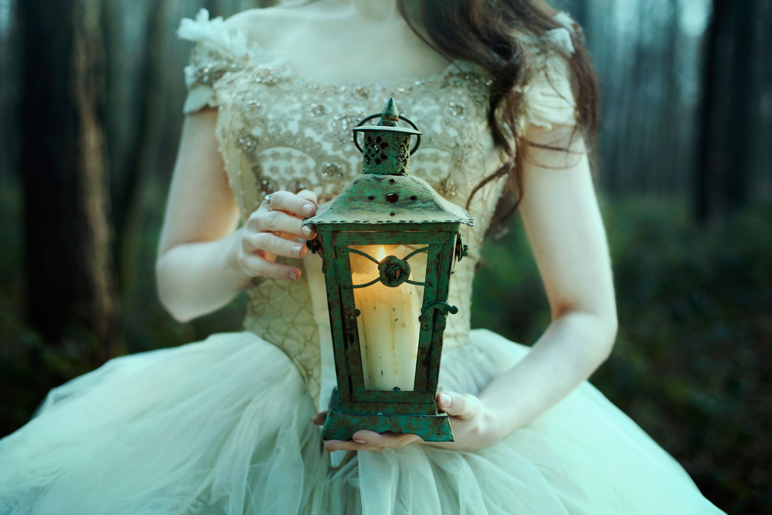 Beautiful woman in white gown with lantern