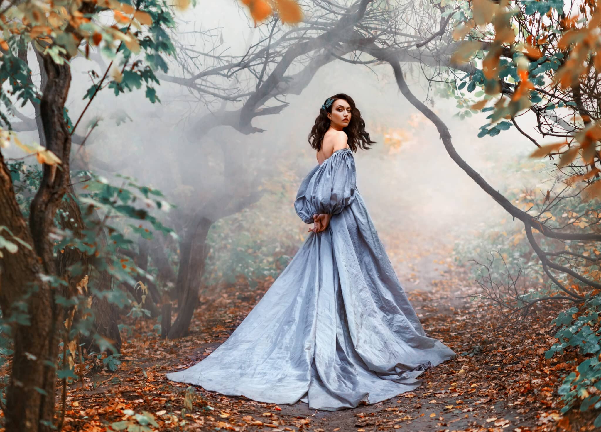 queenly woman walks in mystical autumn misty forest