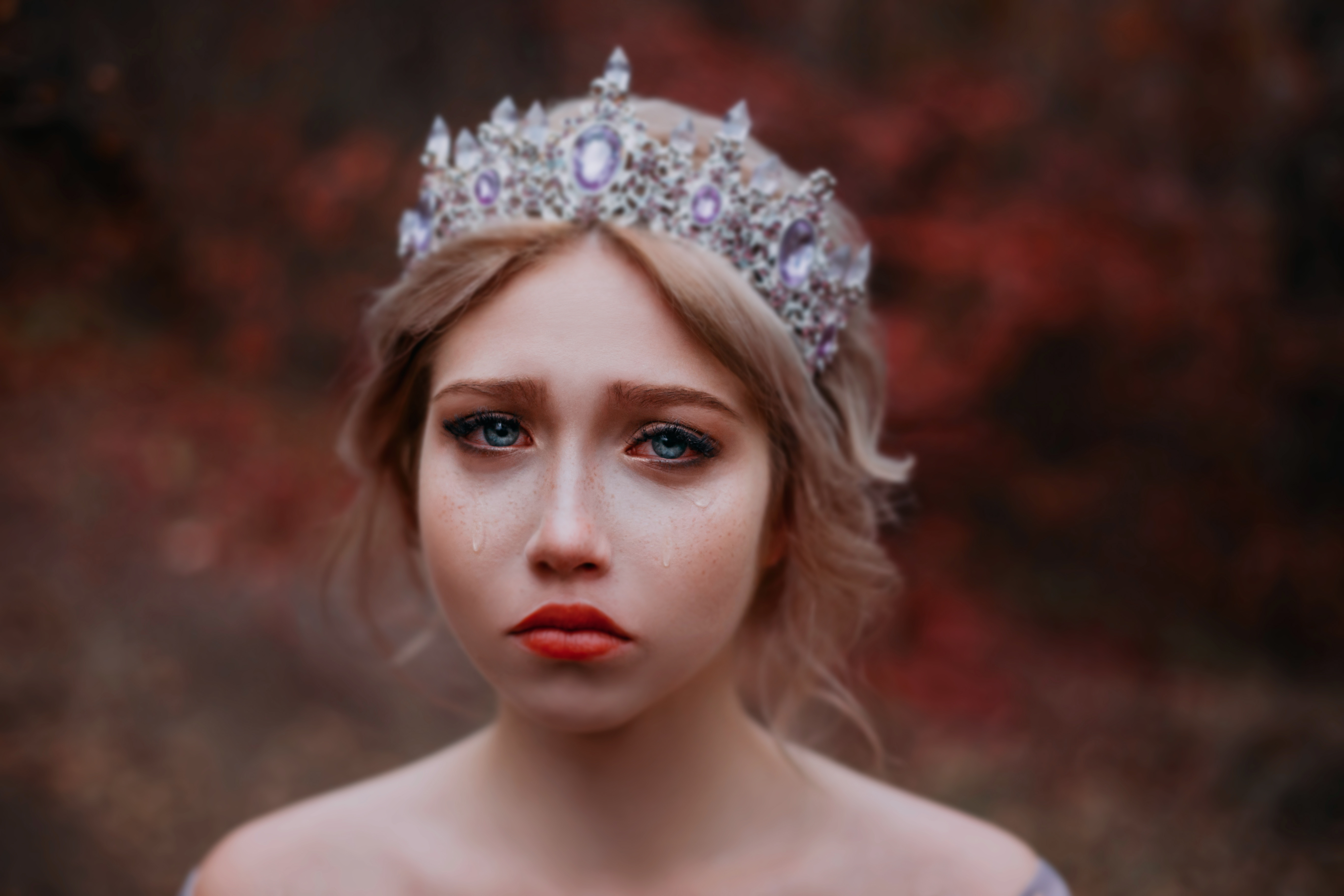 Сlose-up emotional portrait of beautiful sad girl princess crying. 