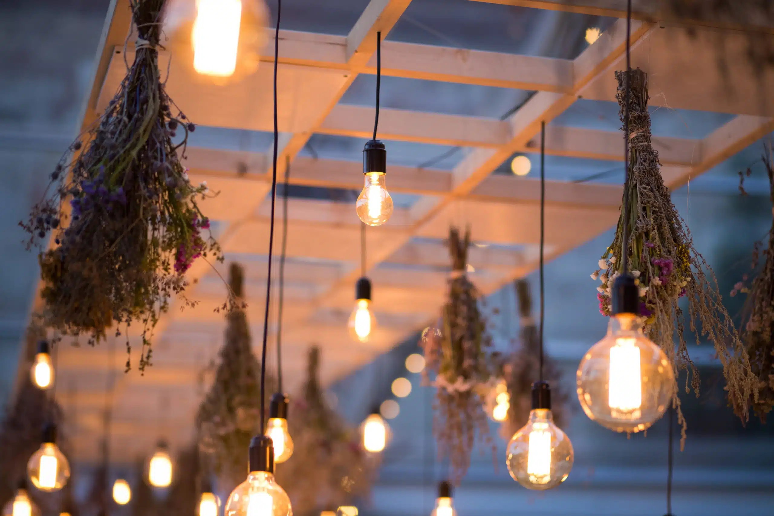Yellow lights and hanging dried flowers , boho style wedding decor