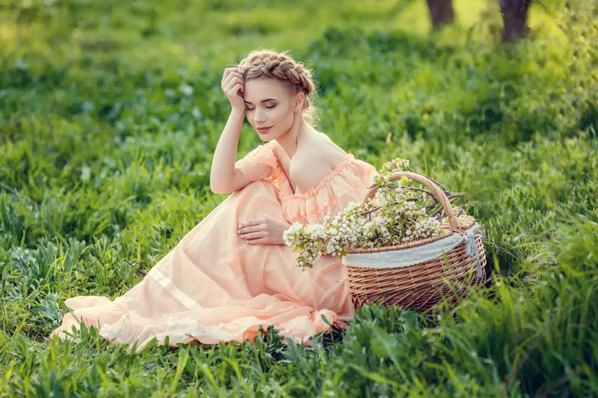 beautiful young lady in vintage dress in a pear-blossoming garden