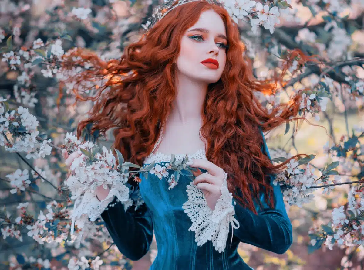 a lovely red haired princess in blooming spring garden