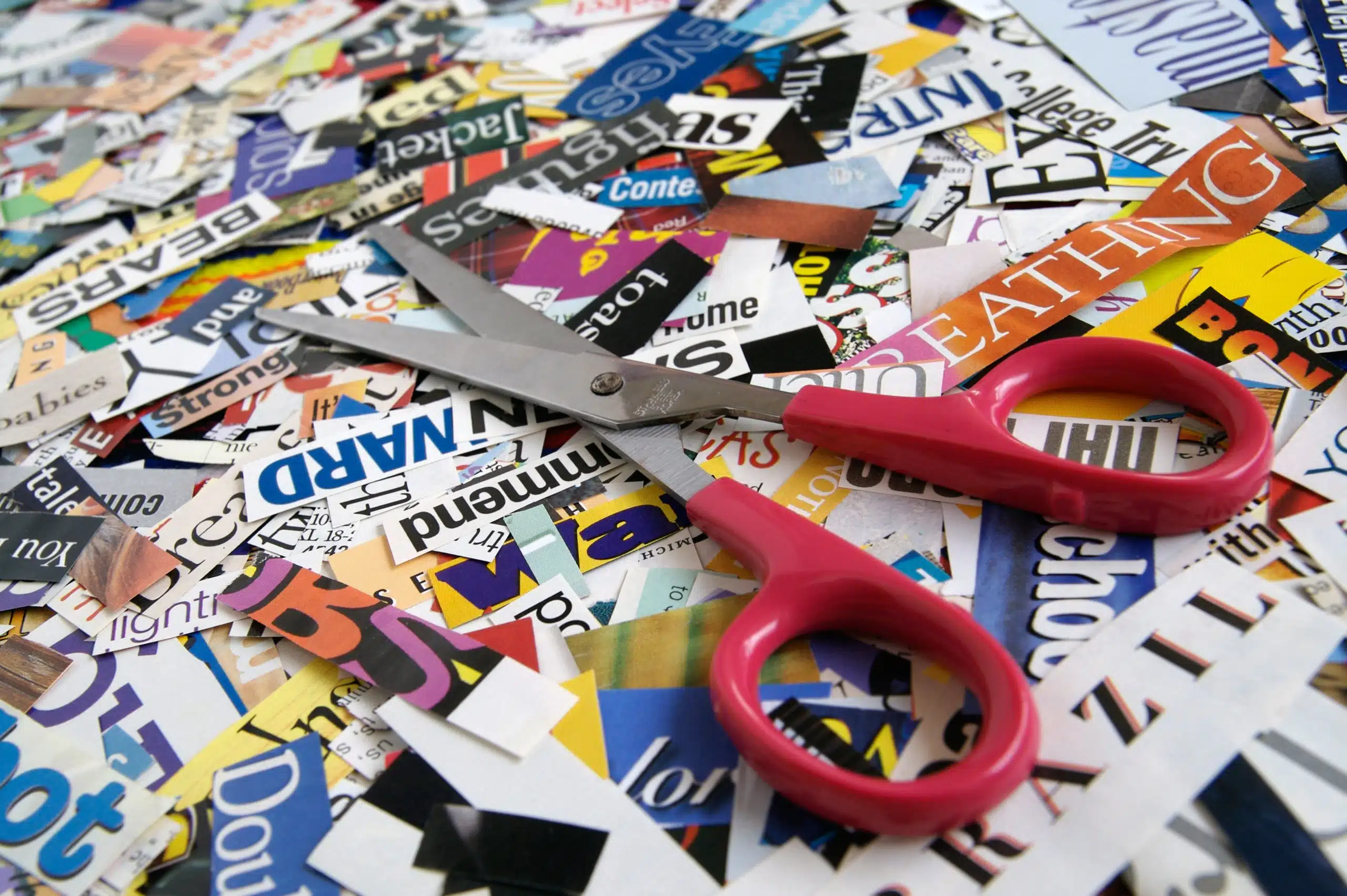 Scissors on magazine clippings.