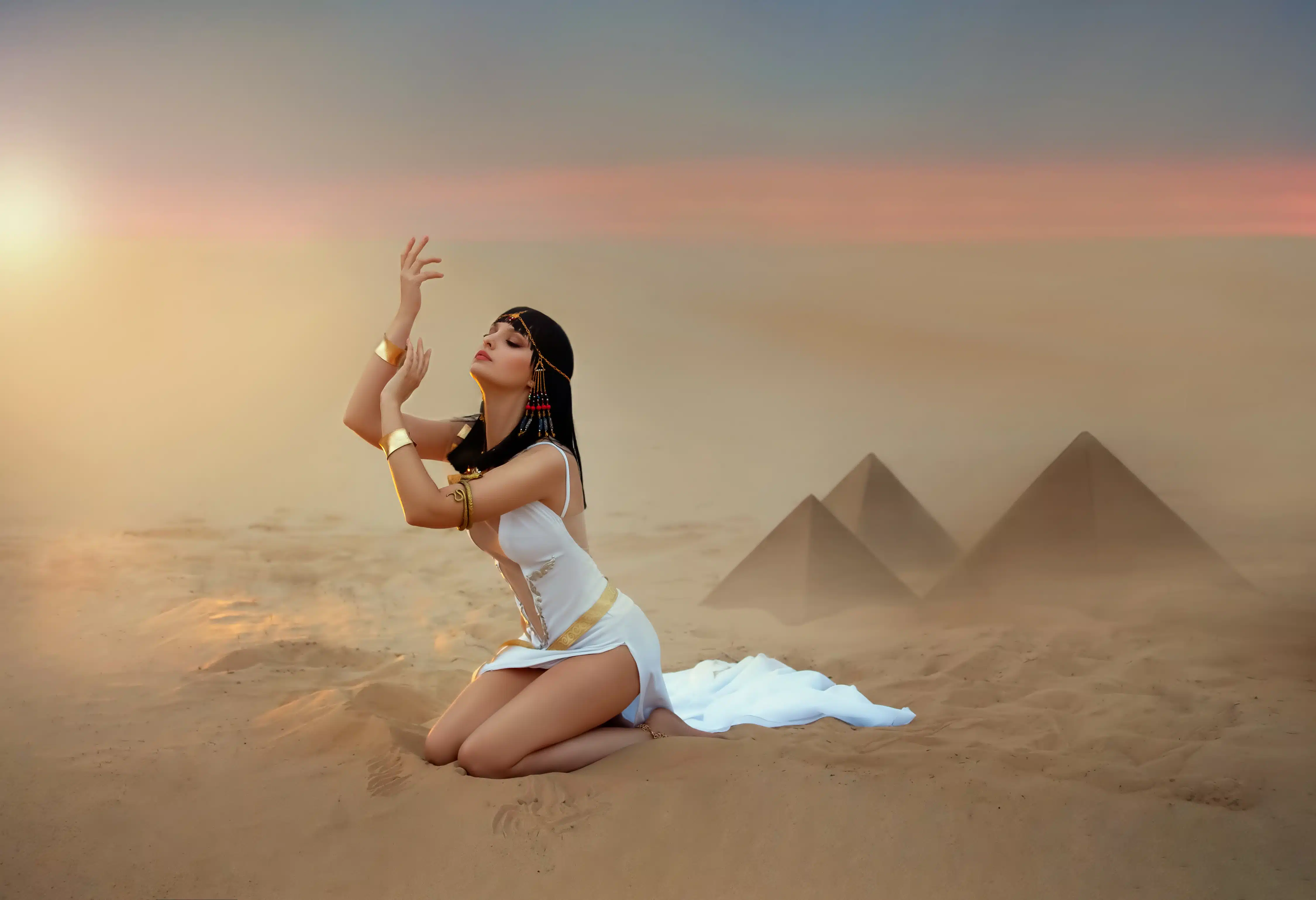 egyptian woman sits on sand desert praying to the sky