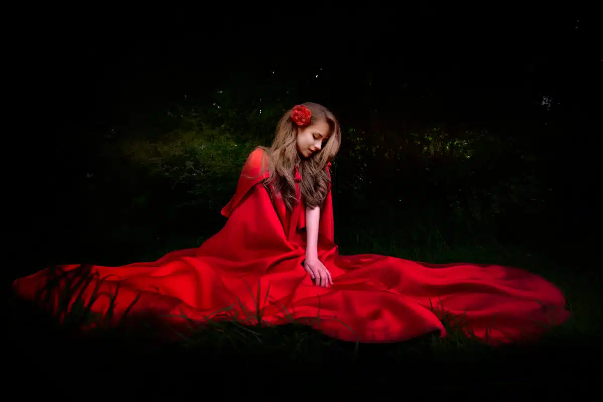 beautiful woman with red cloak in the woods