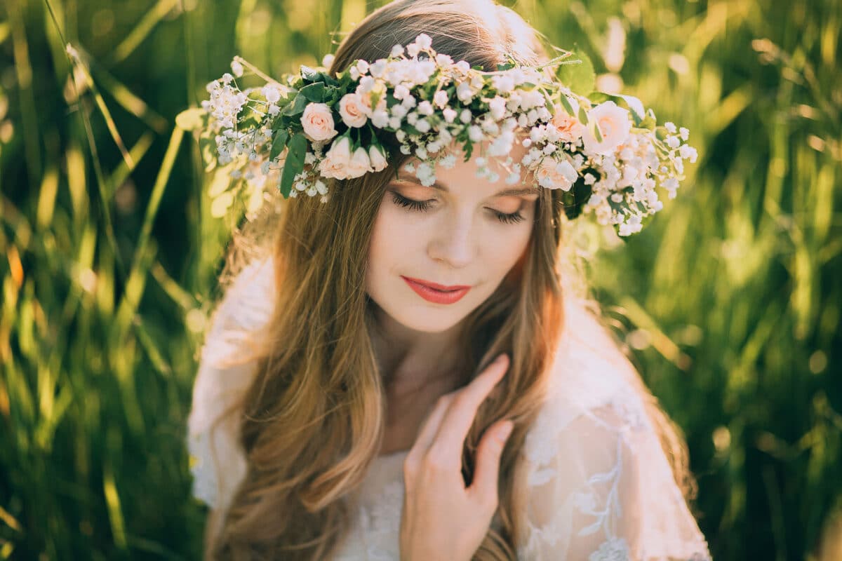 Beautiful young woman with wreath of wildflowers in their hair.