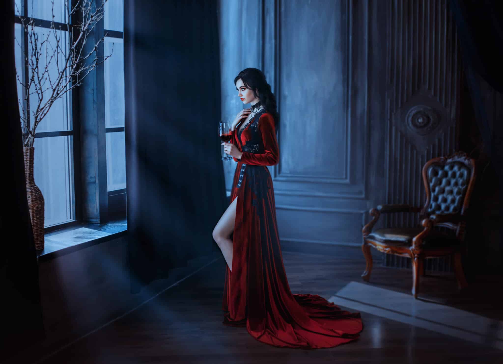 Beautiful young sexy woman vampire in medieval dark castle. 