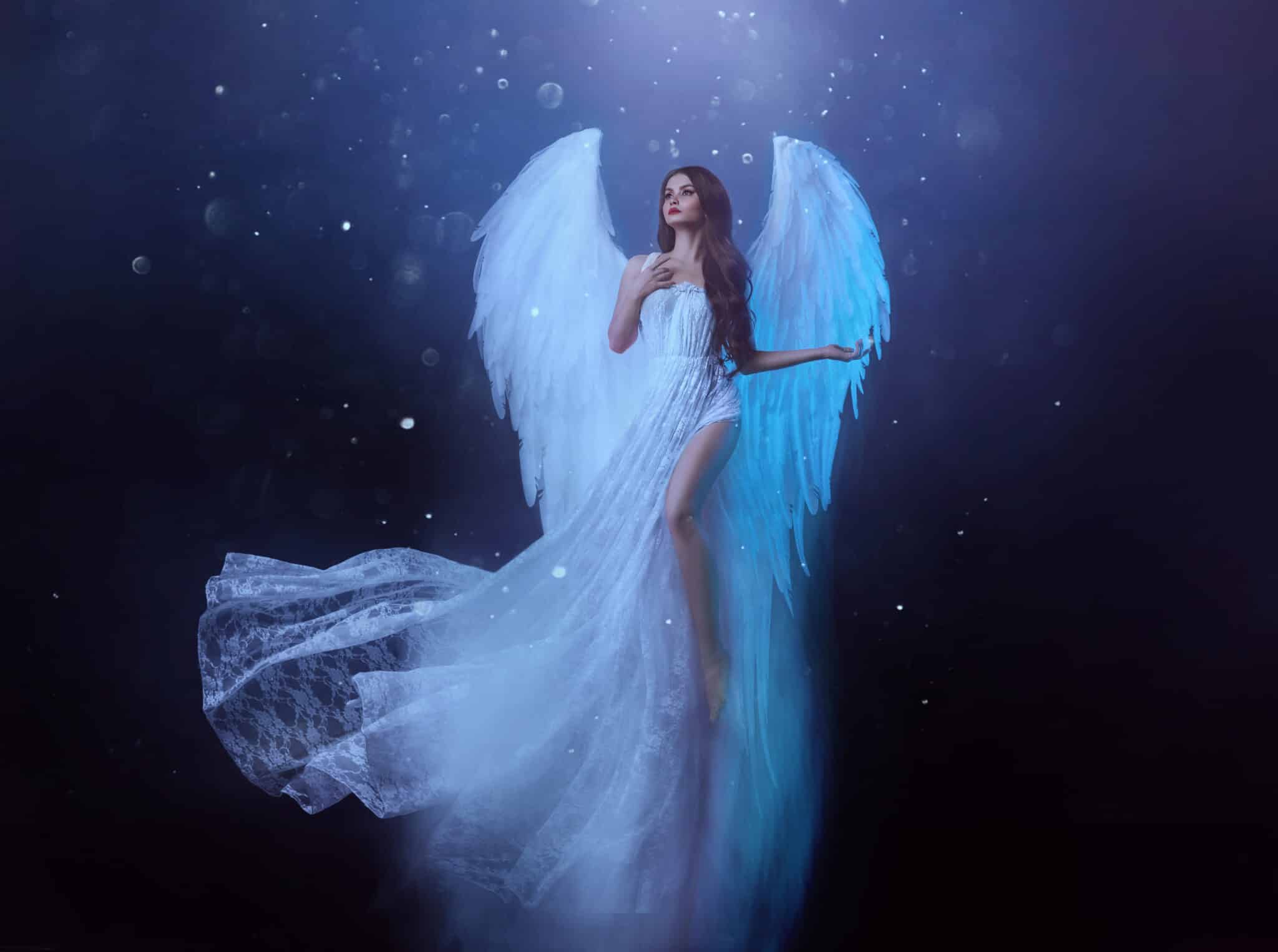 Fantasy woman angel soars in the air with white huge bird wings.