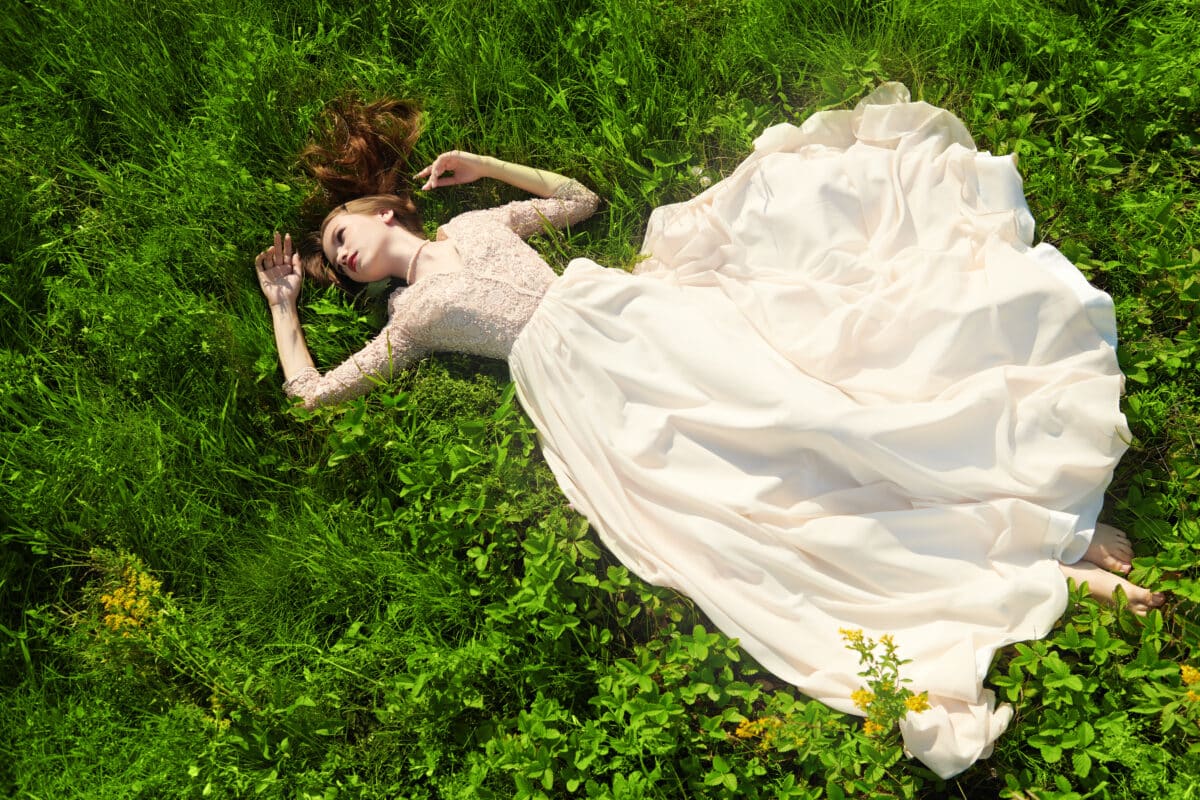 dreamy girl lying on grass