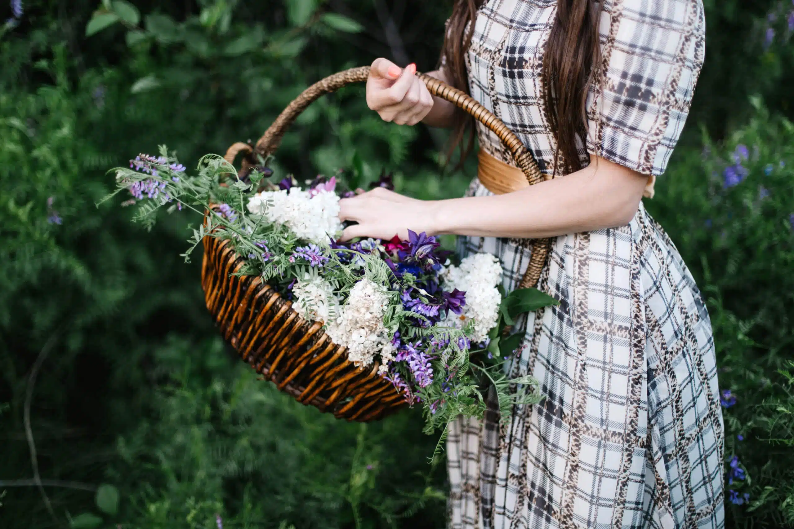 woman holding a basket of flowers