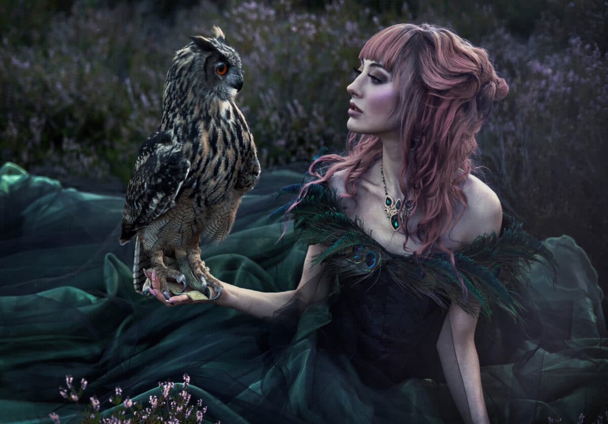 beautiful woman with owl in the nature