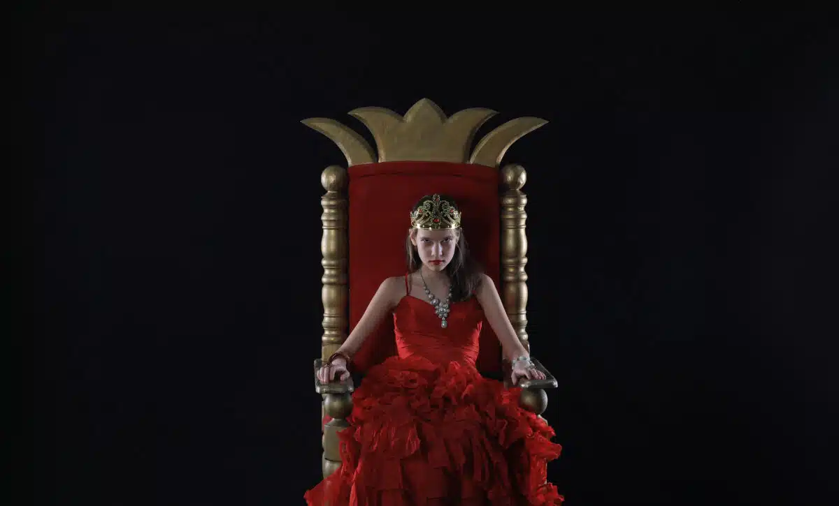 serious young princess on the throne