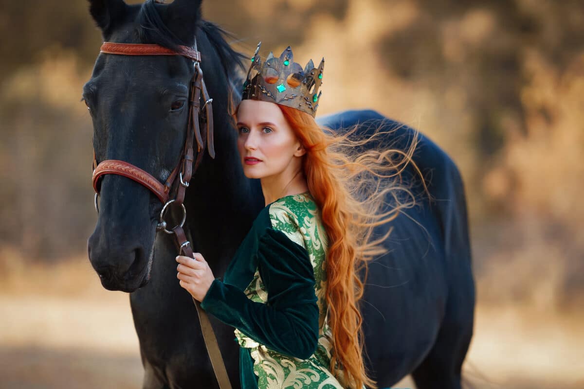 her horse and a serious queen with a crown in a long green dress holding a sword 