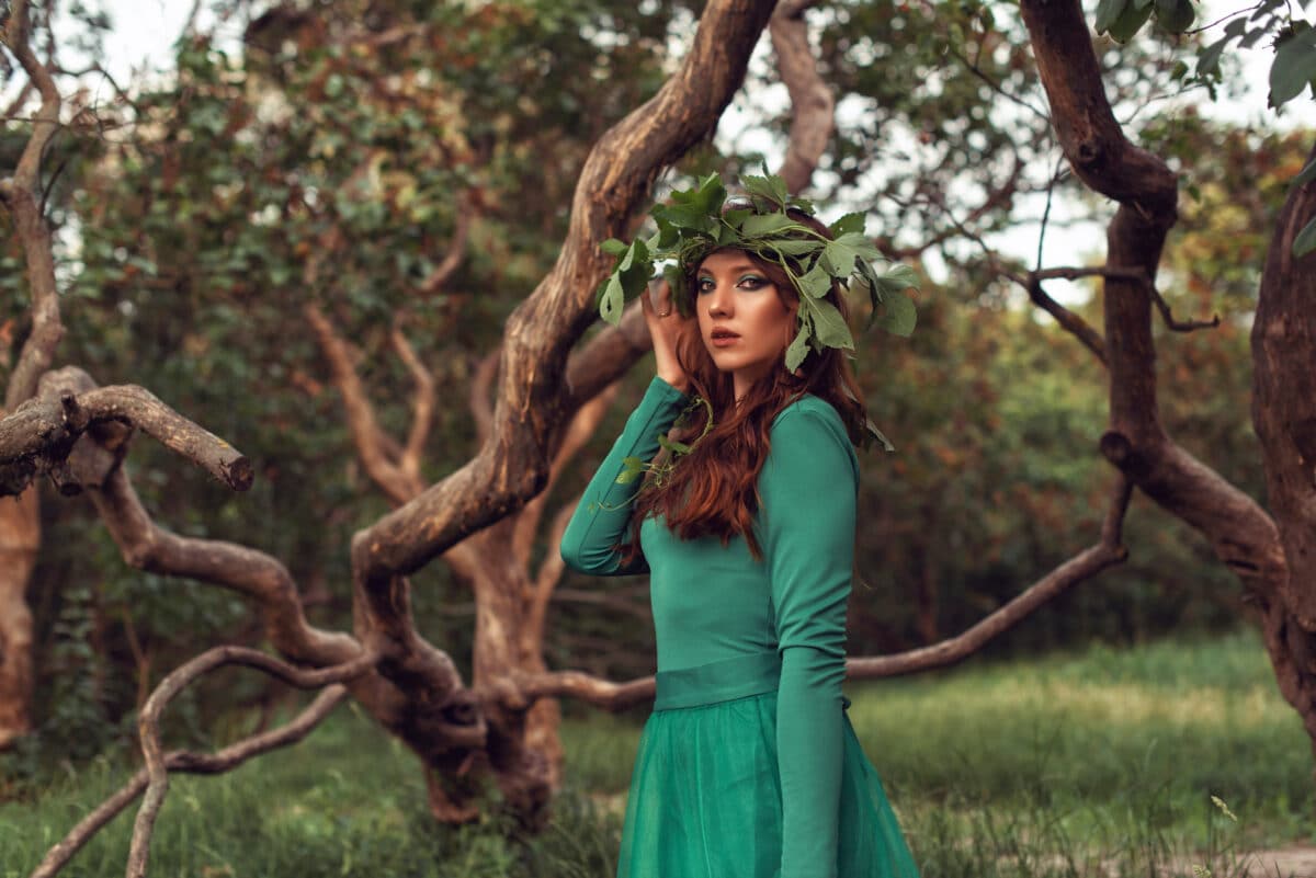 Young woman in green dress in the park