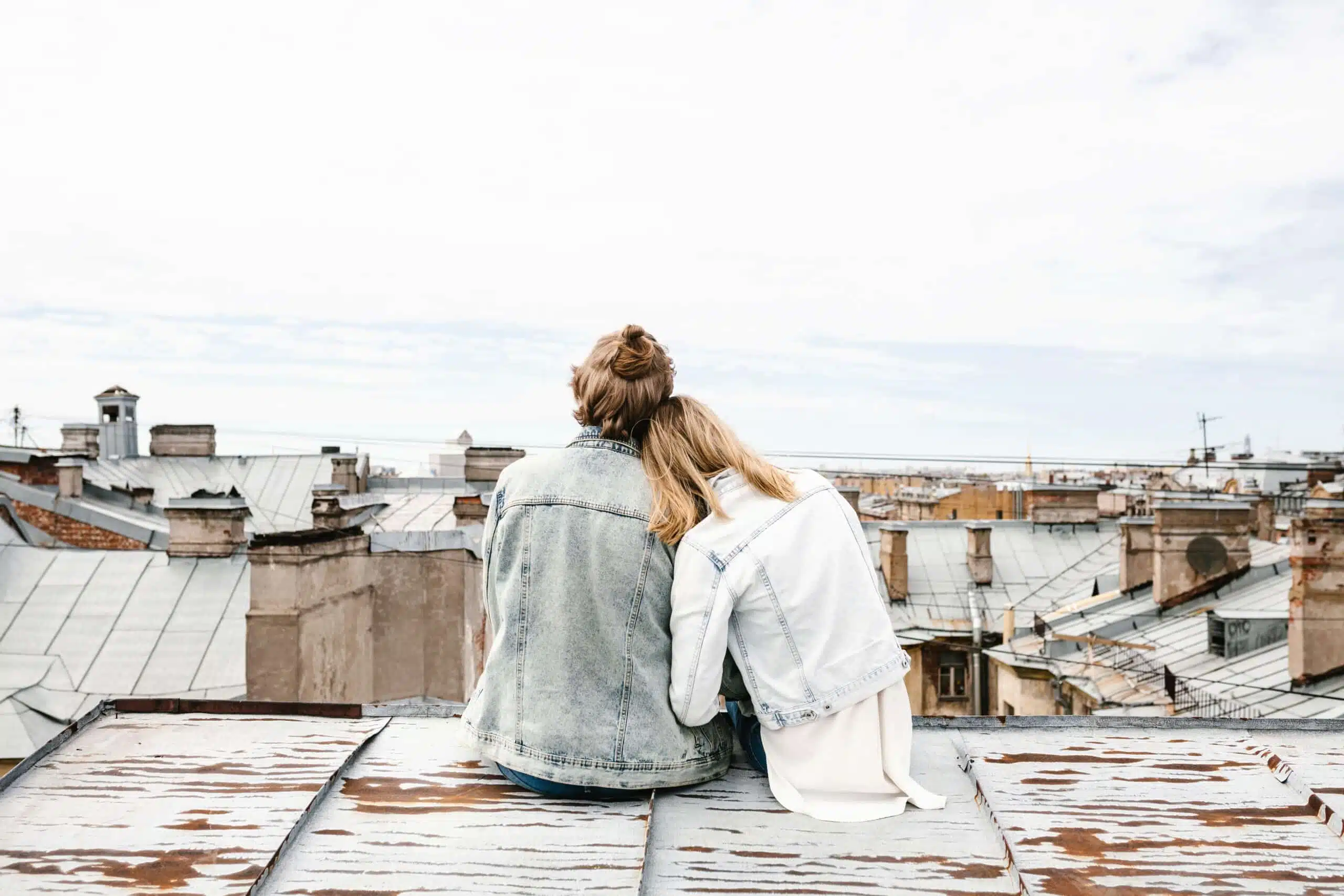 Young couple sitting on the roof.
