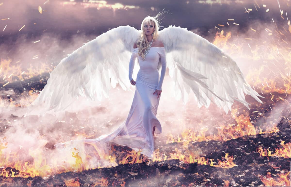 a white angel walking on hell flames