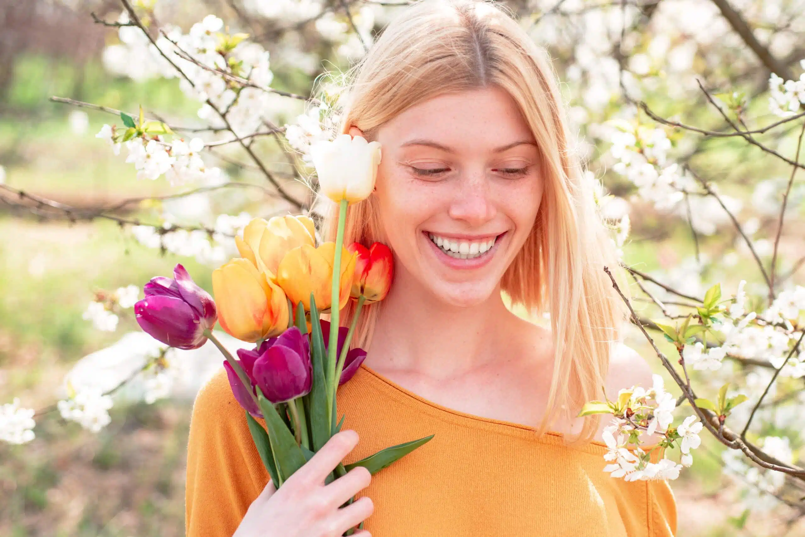 young woman enjoying spring flowers