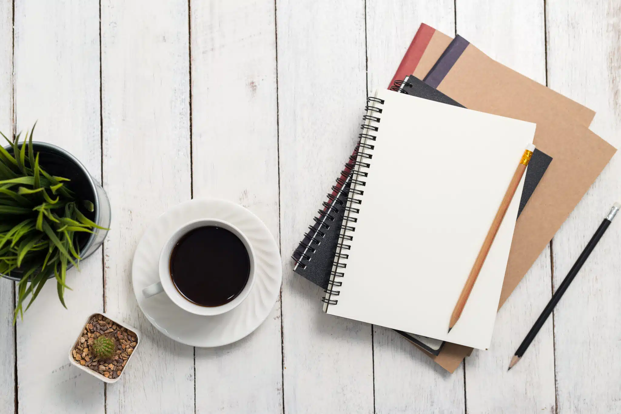 Empty notebook and coffee on  wooden table