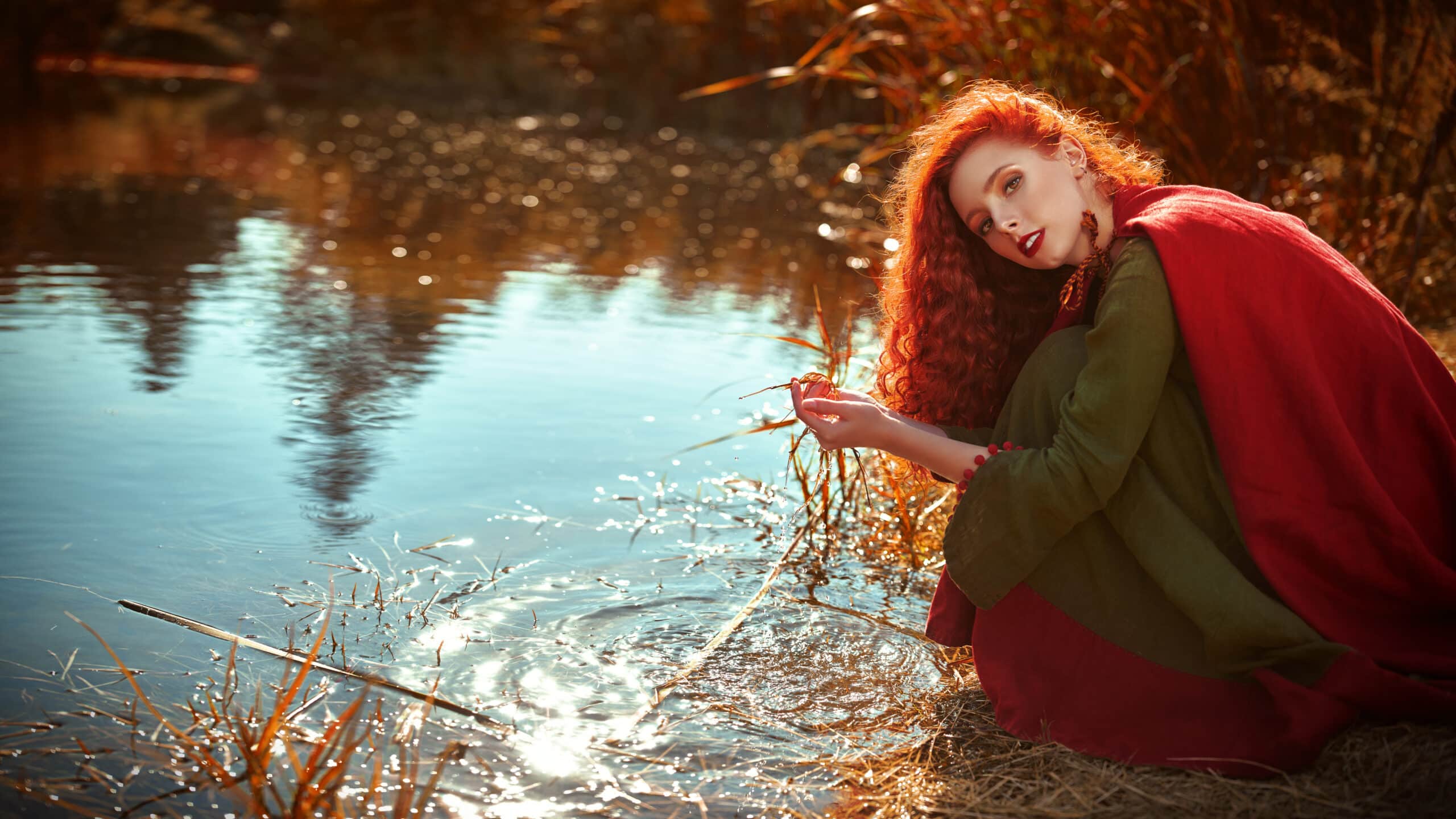 beautiful redhead dipping in the river, during the ancient celtic times
