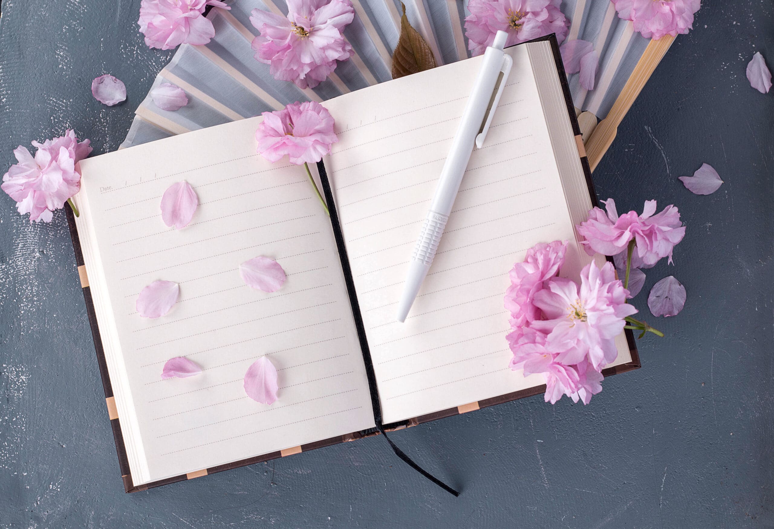 Sakura flowers and note book with a pen