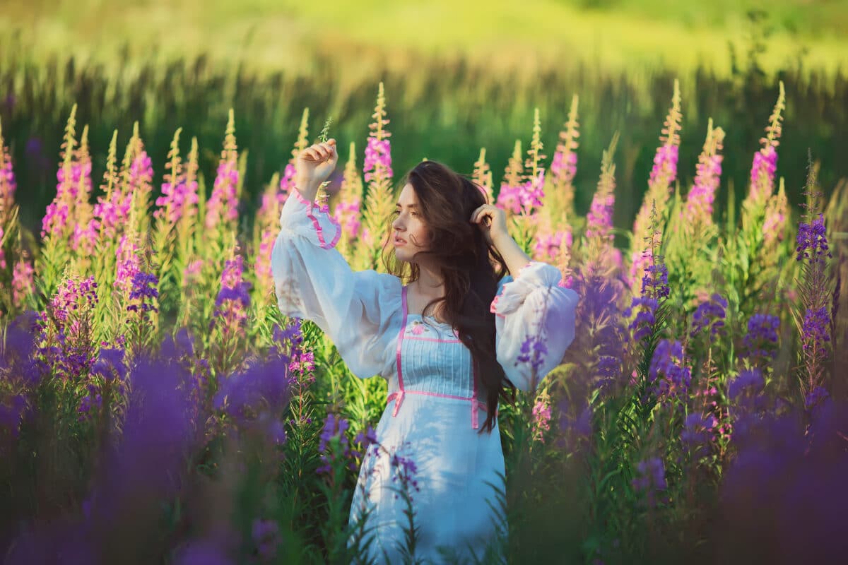 a beautiful woman on a lavender field at sunset
