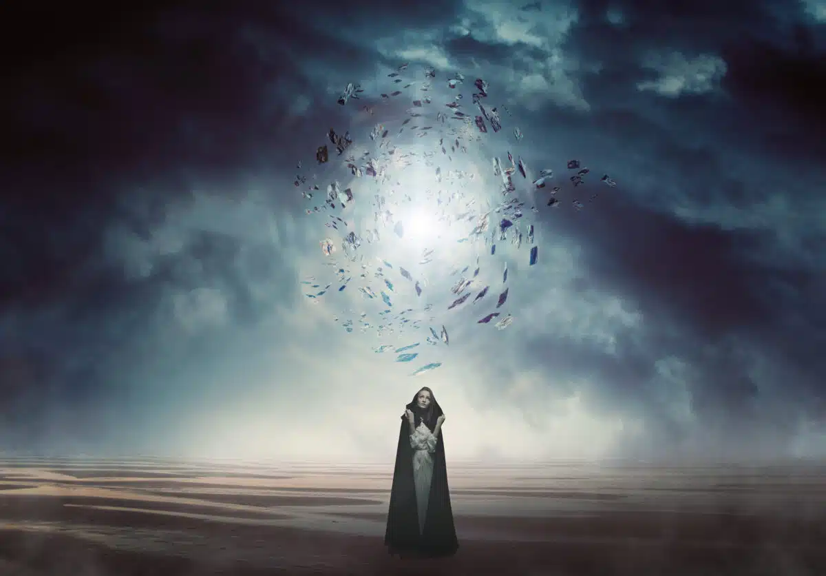Mysterious woman in a magical and strange land with dark storm clouds above her