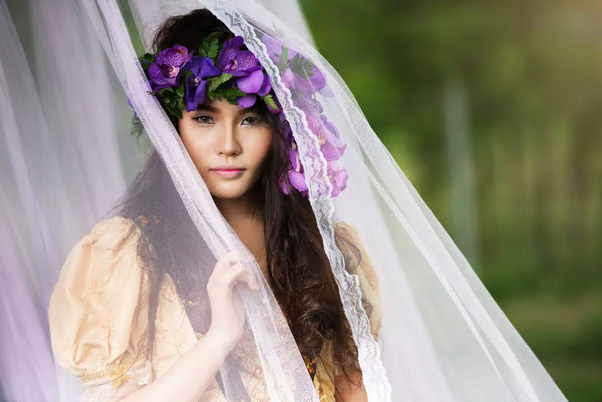 enchanting princess wears a violet flower head wreath and veil