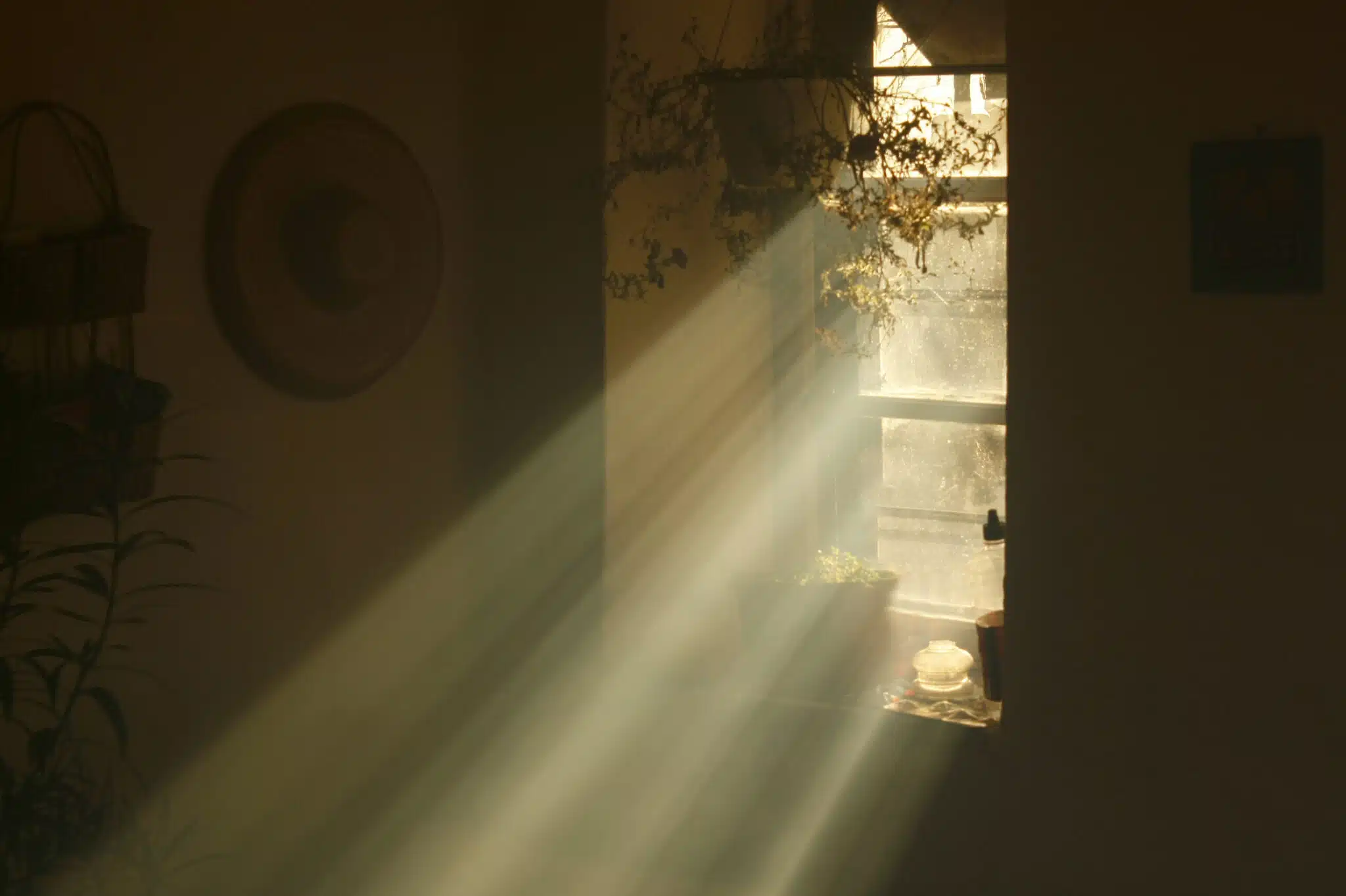 rays of light coming from a window in an old country house