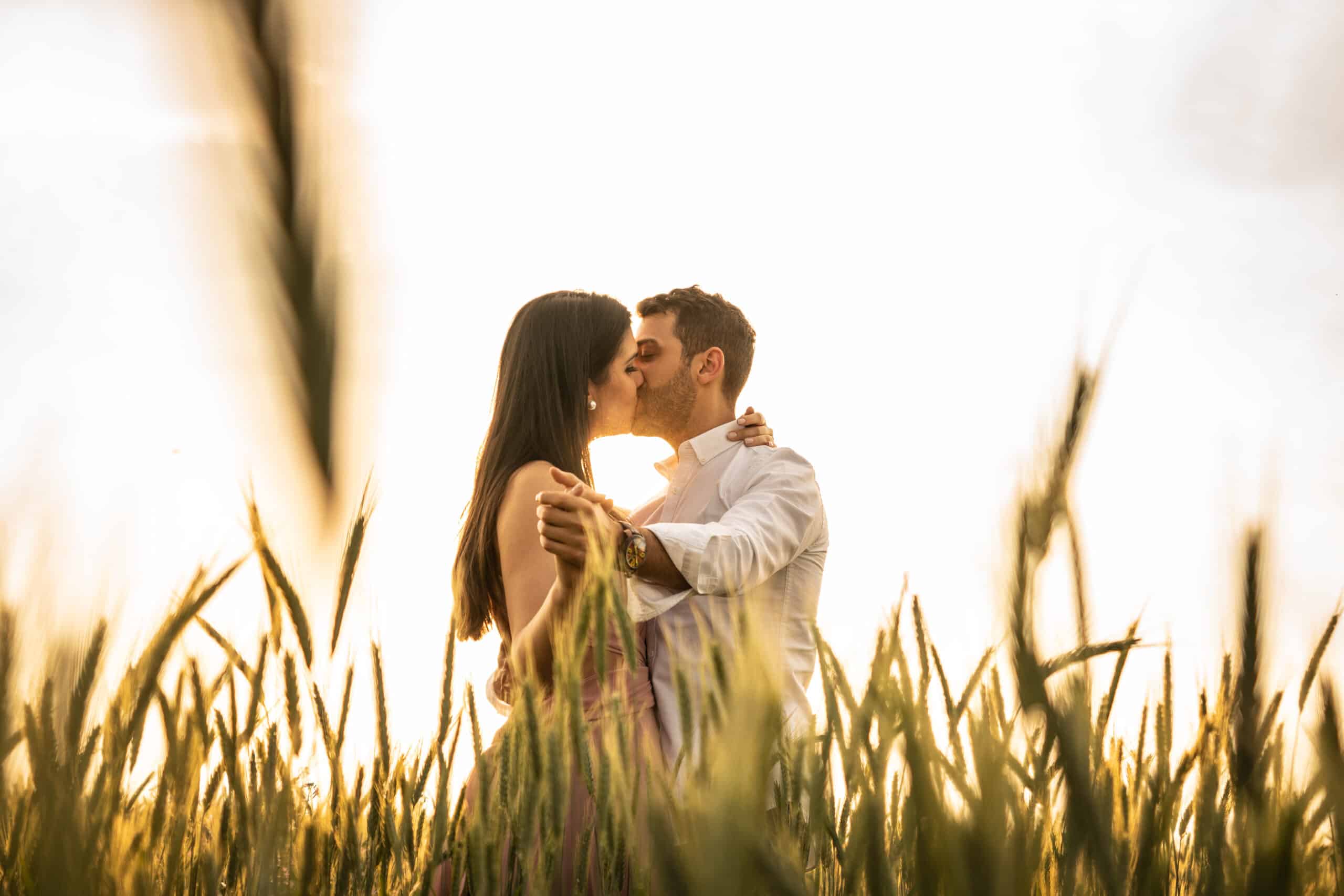 Romantic couple dancing on love moment at gold wheat field