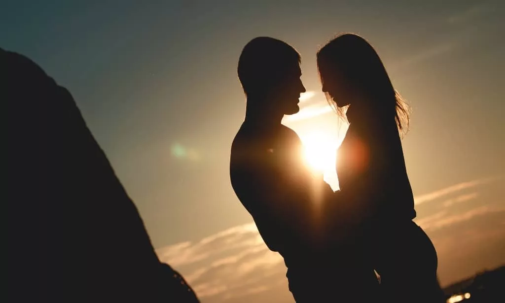 Silhouette of romantic couple in the park outdoors.