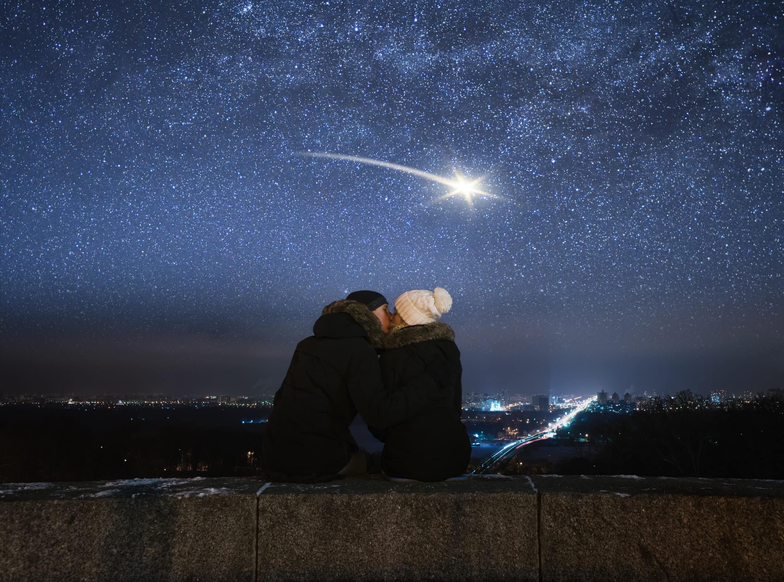 Loving couple kissing under the night sky