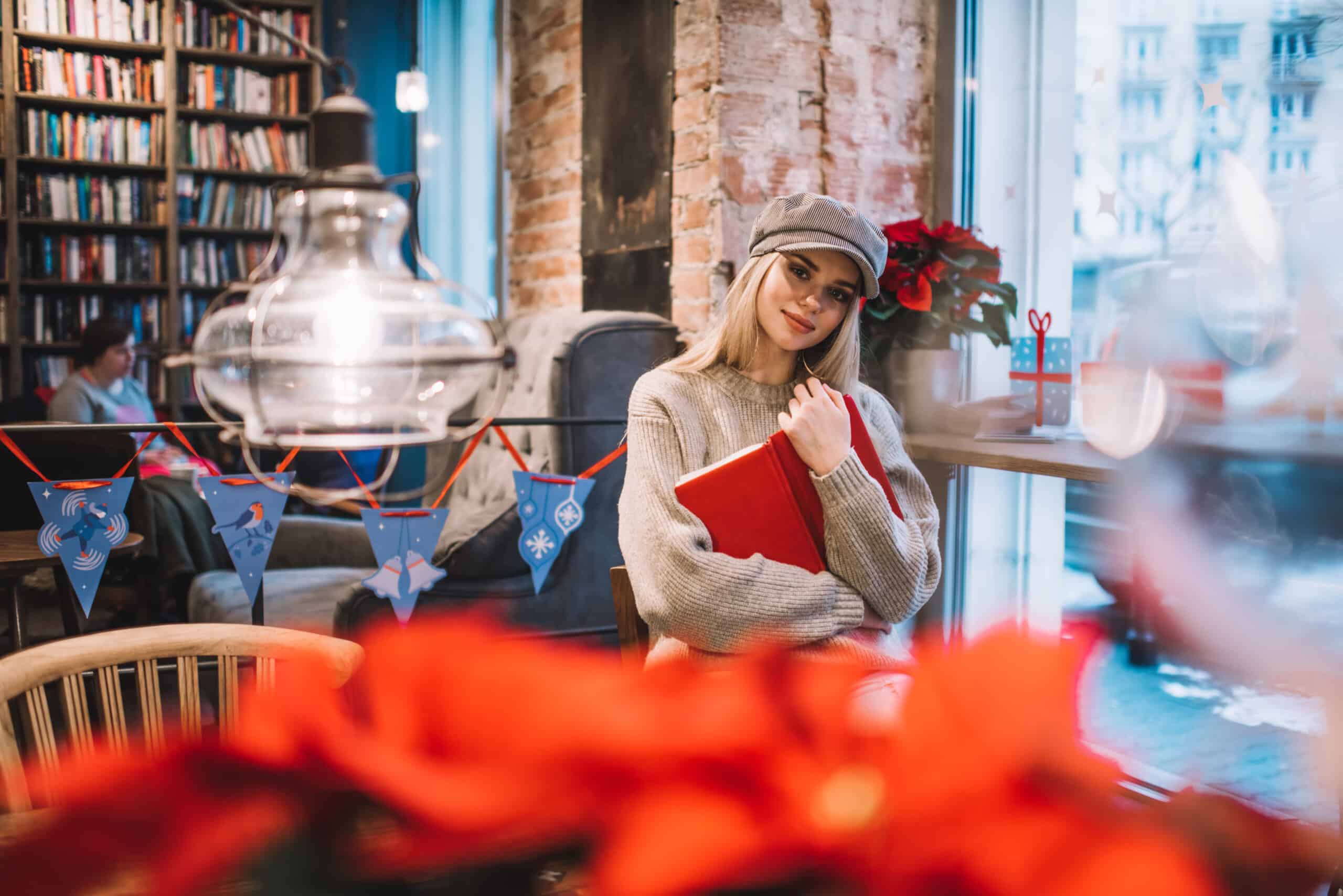 beautiful hipster girl in trendy cap holding personal diary
