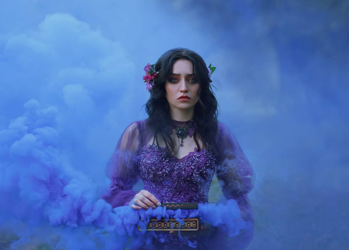 Casket Padora. Sad girl holds the evil gift of the gods - a box that is filled with evil. A woman cries that she could not contain her curiosity and released trouble. Background blue smoke.