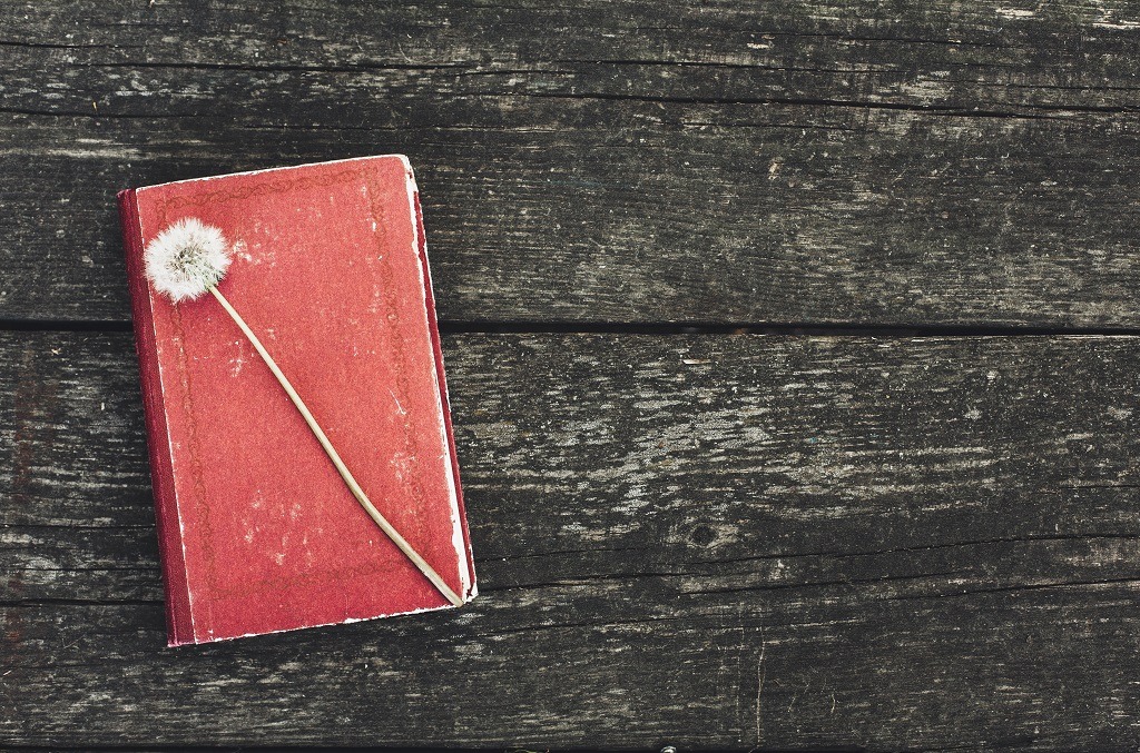 Vintage poetry book on wooden platform