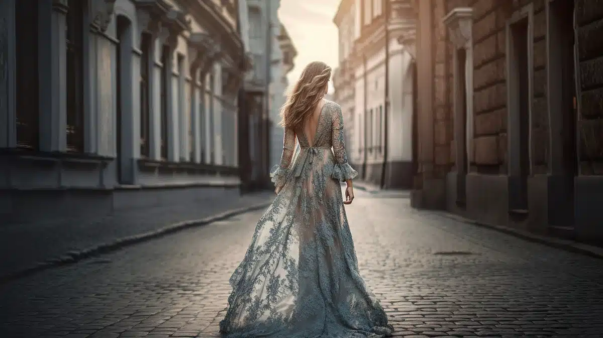 a beautiful young woman in a long dress walking in a lonely city