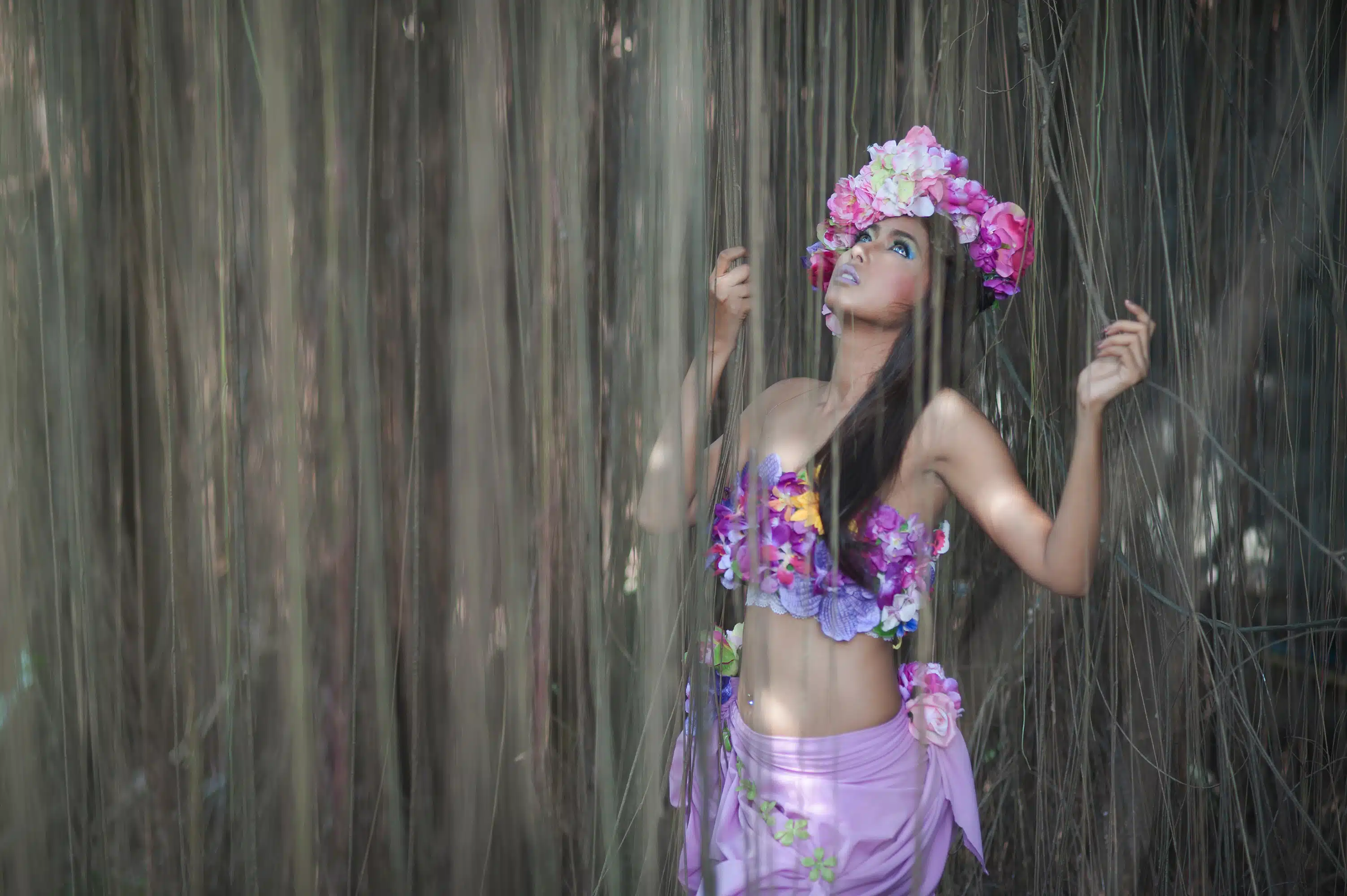 Young Asian Woman Tanned Skin And Black Shine Long Hair with flowers costume design. 
