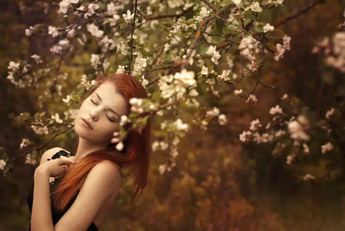 beautiful redhead in a spring garden