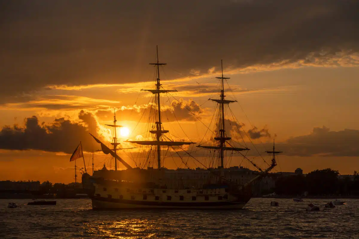 Vintage sailing ship in the ocean at sunset