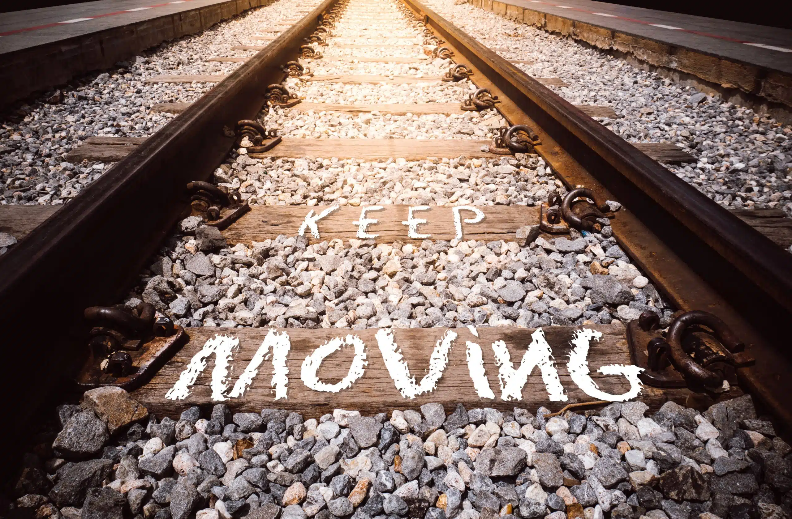 Keep moving phrase written on railway.