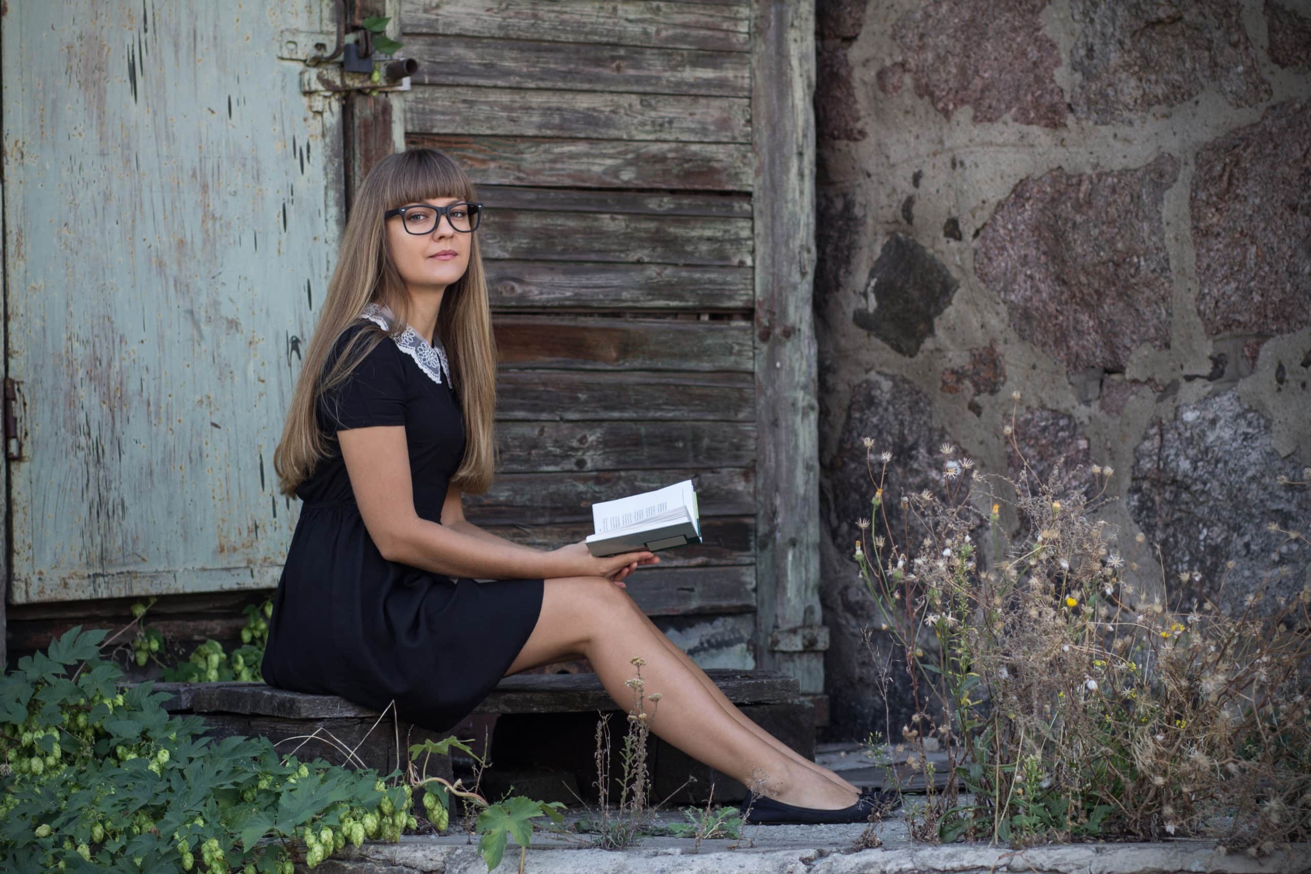 Beautiful retro girl in glasses with a book