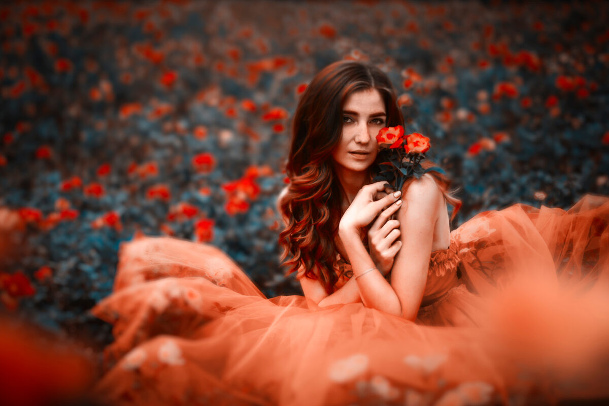 Beautiful woman in garden of roses
