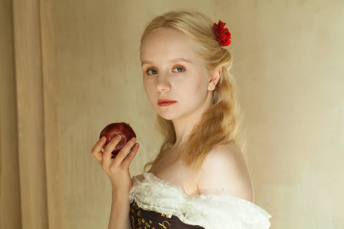Romantic vintage woman with a red apple in her hand