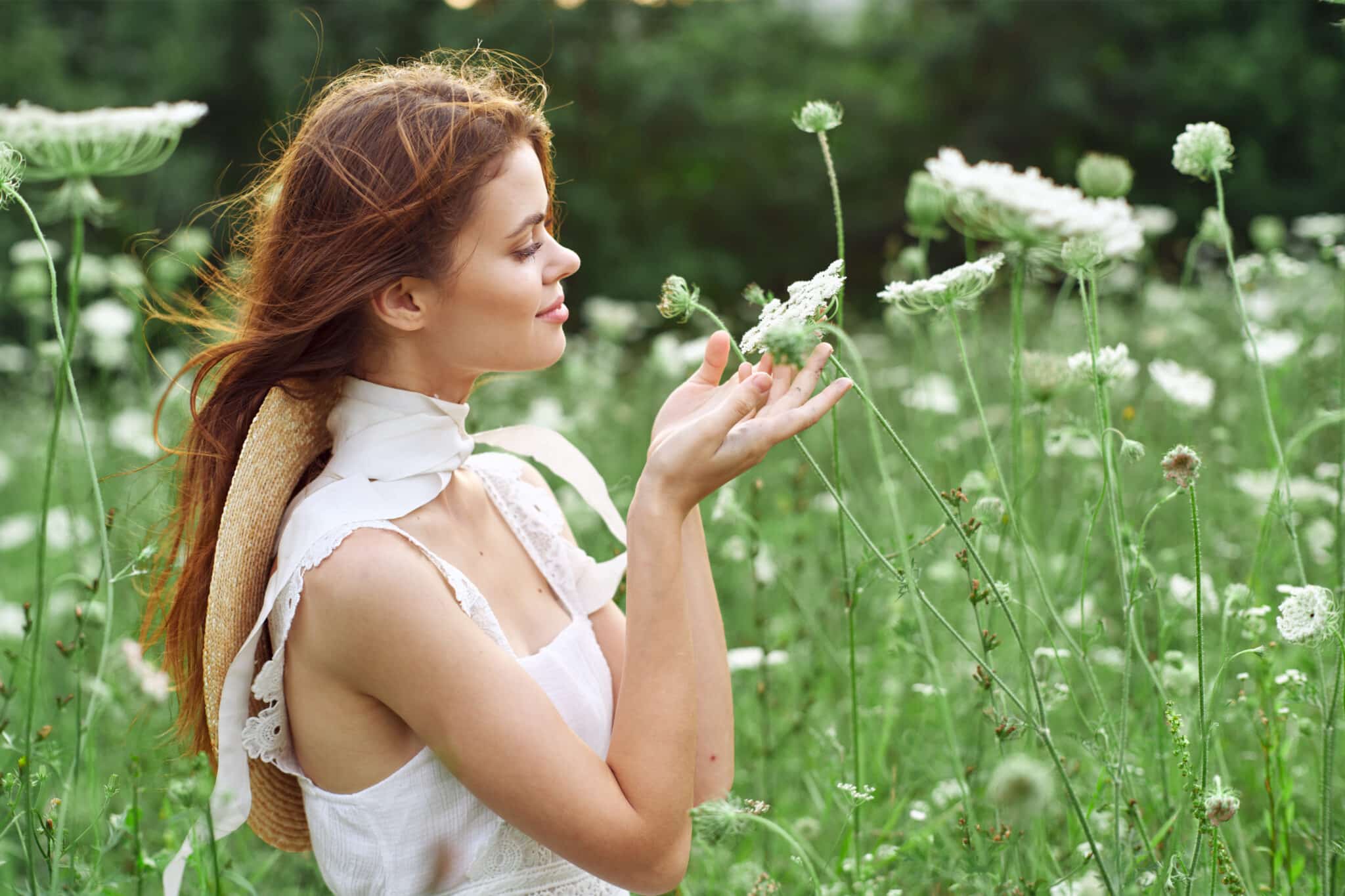 pretty woman in white dress in a field of white flowers 