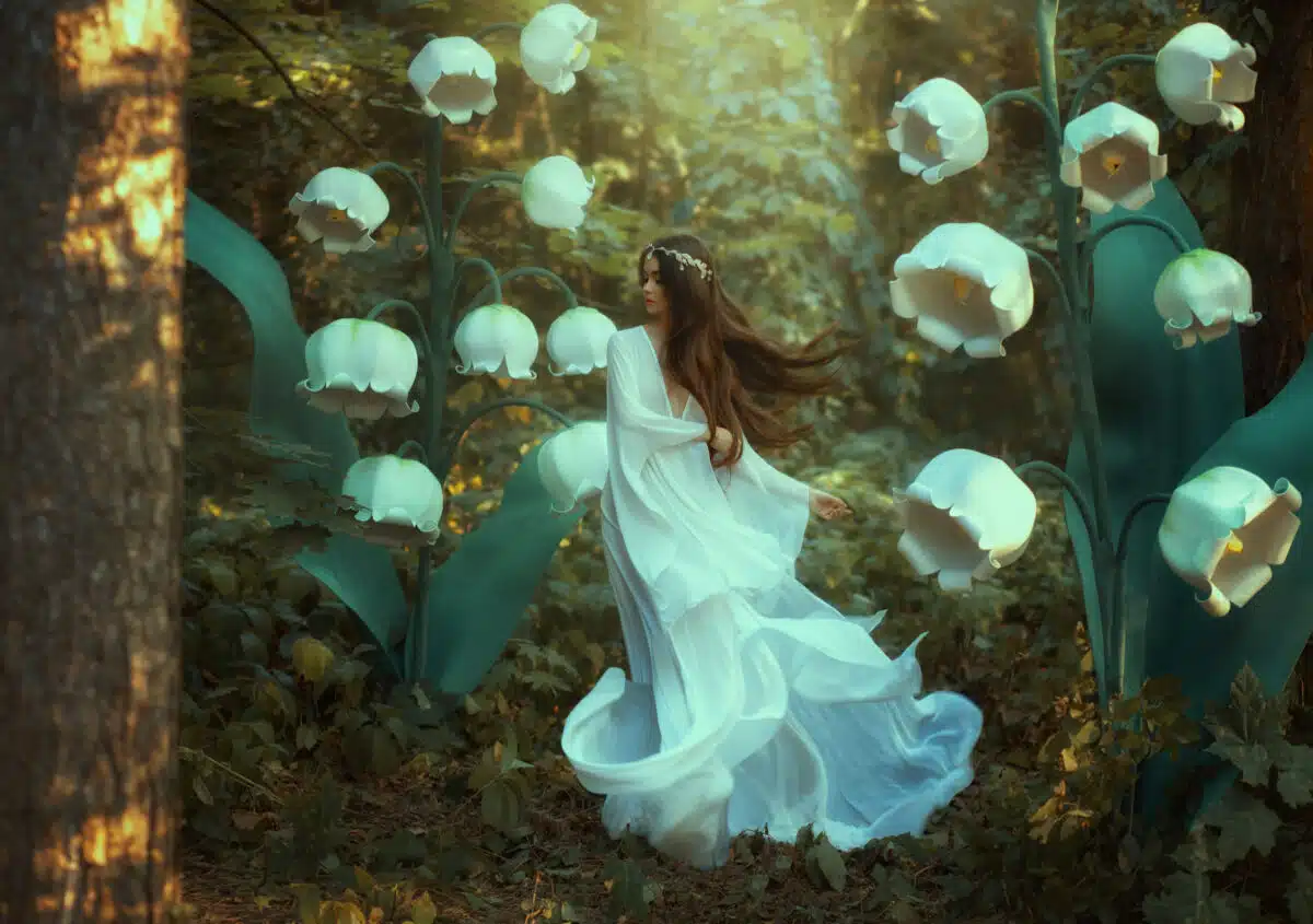 A beautiful elf walks in a fantasy forest with lilies of the valley