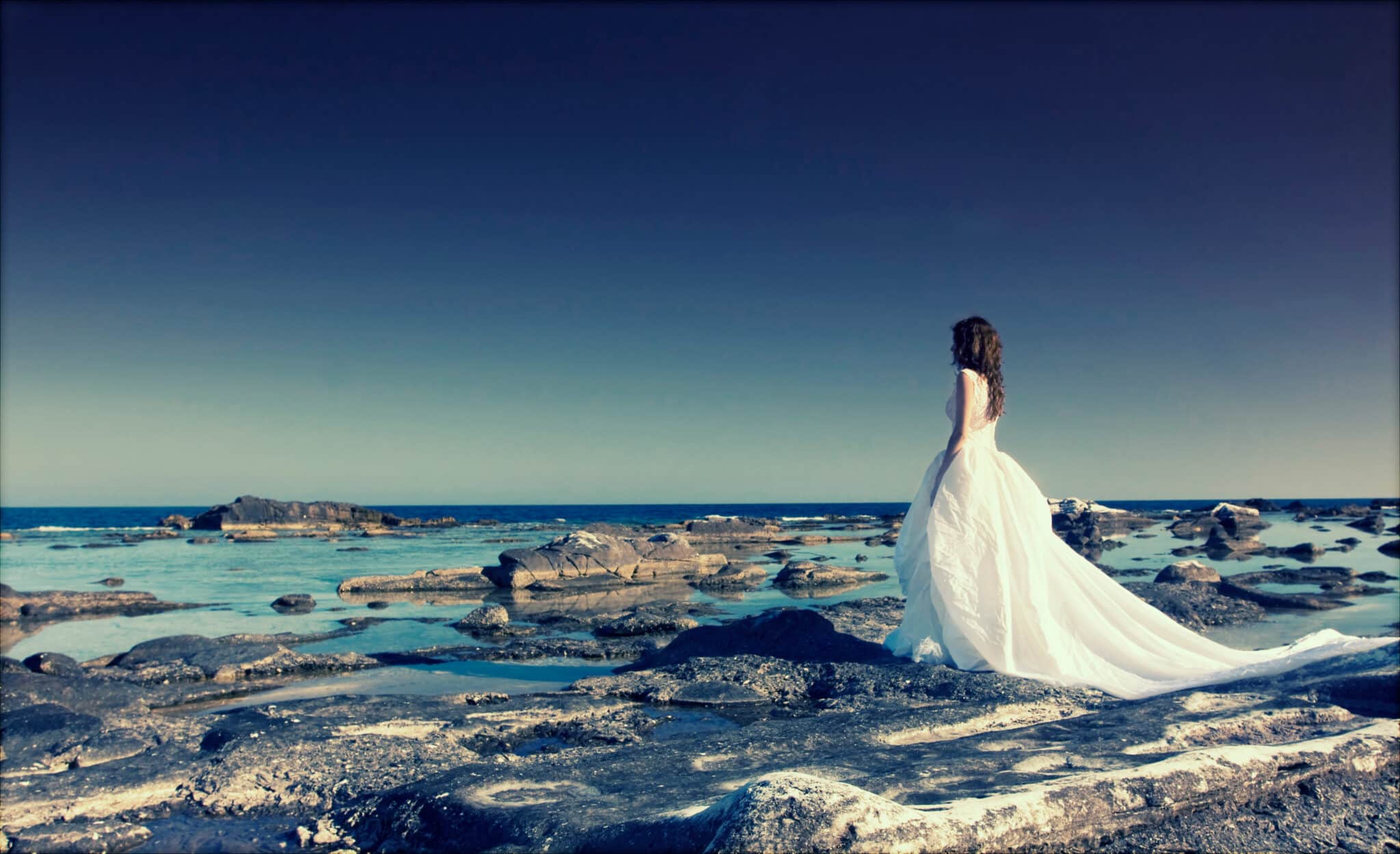 woman in white looking at the sea