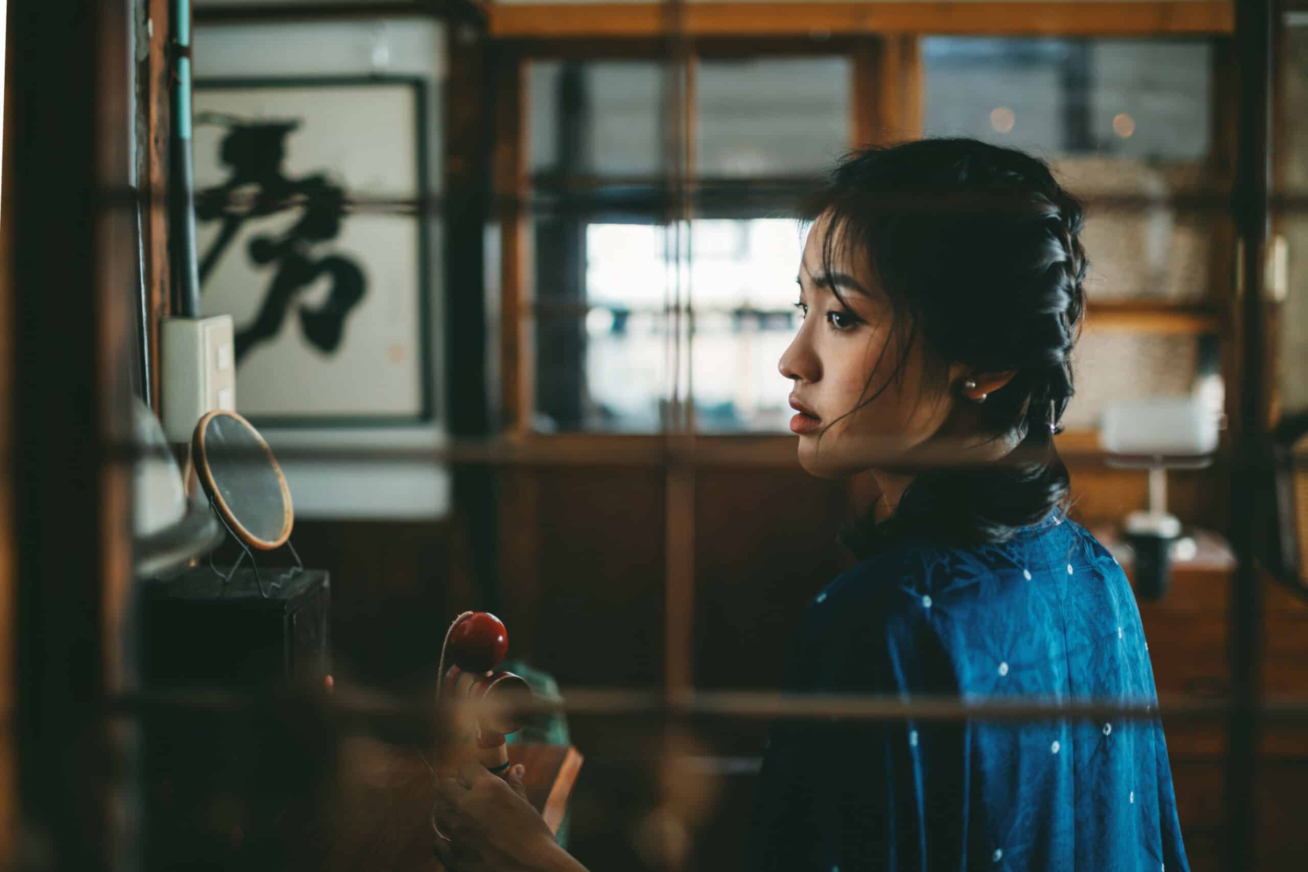 a japanese girl looking out the window sideways