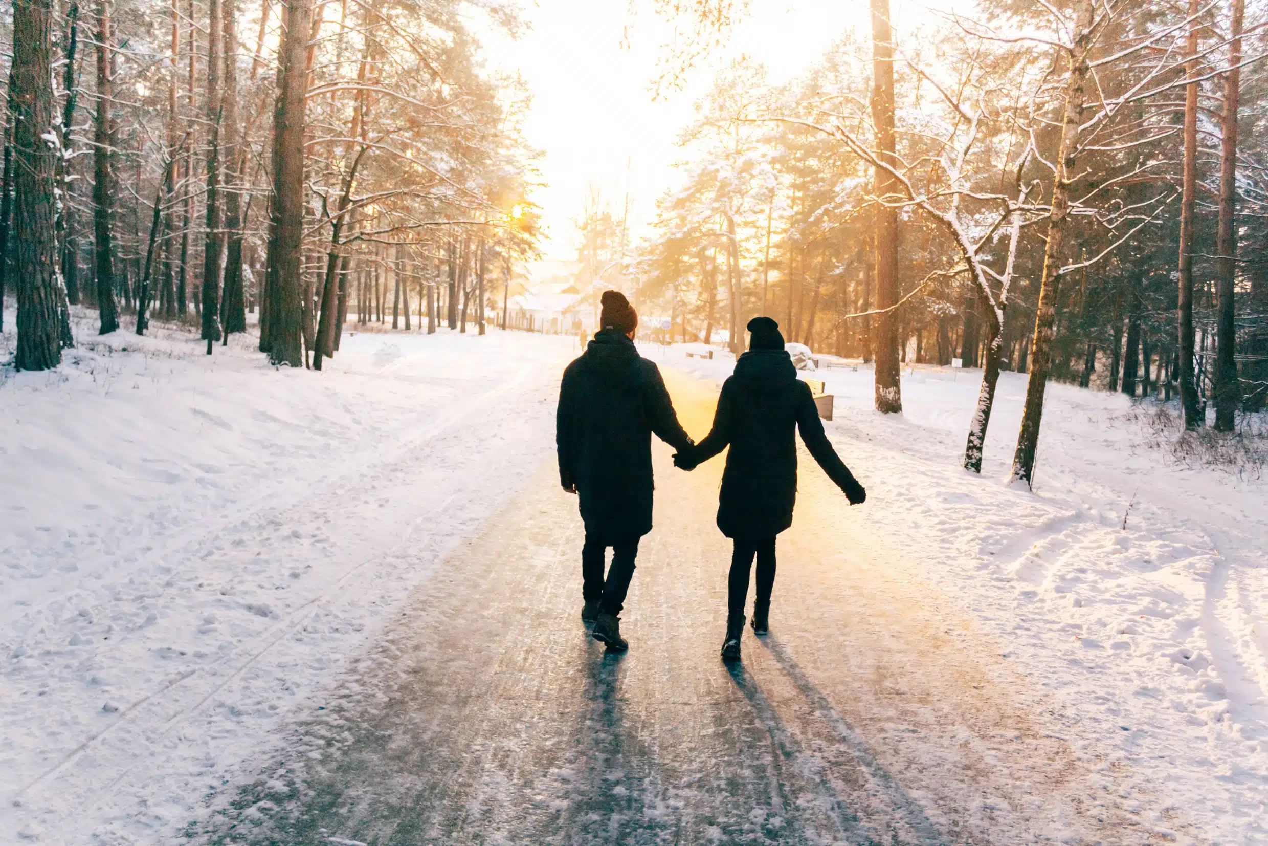 Couple holding hands while walking outdoor in winter